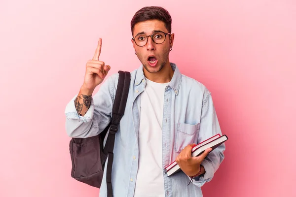 Young Caucasian Student Man Holding Books Isolated Pink Background Having — ストック写真