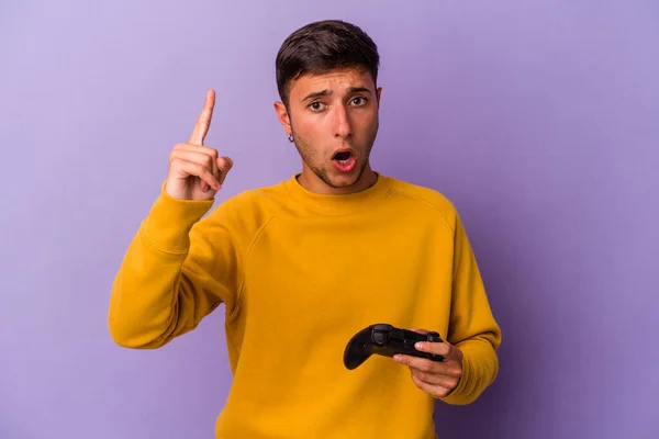 Young Caucasian Man Holding Game Controller Isolated Purple Background Having —  Fotos de Stock