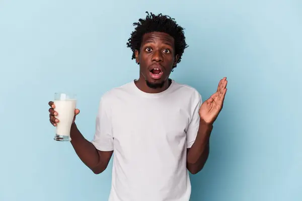 Young African American Man Holding Glass Milk Isolated Blue Background — 스톡 사진