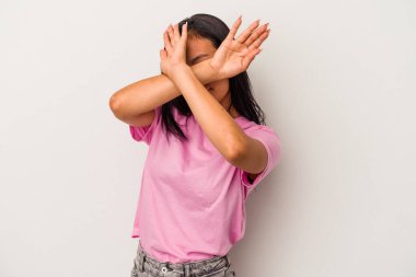 Beyaz arka planda izole edilmiş genç Latin kadın iki kolu çapraz tutuyor, inkar kavramı.