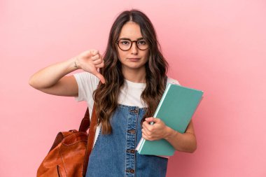 Young caucasian student woman isolated on pink background showing a dislike gesture, thumbs down. Disagreement concept.
