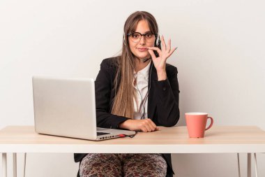 Beyaz arka planda tek başına seyahat eden beyaz tenli genç bir kadın. Parmakları dudaklarında bir sır saklıyor..