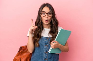 Young caucasian student woman isolated on pink background having some great idea, concept of creativity.