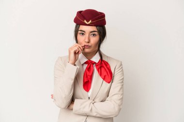 Young caucasian stewardess woman isolated on white background with fingers on lips keeping a secret.