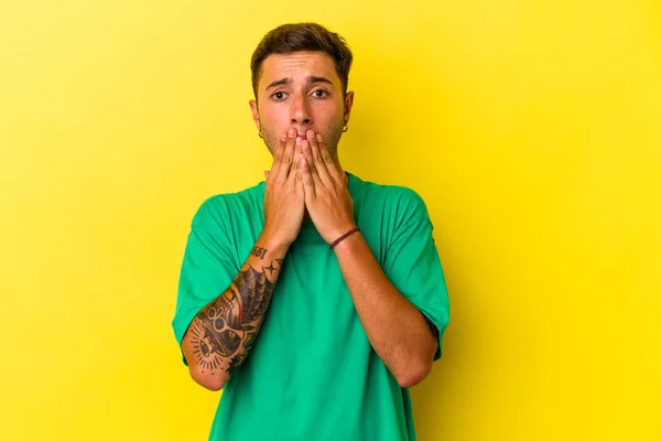 Young Caucasian Man Tattoos Isolated Yellow Background Shocked Covering Mouth —  Fotos de Stock