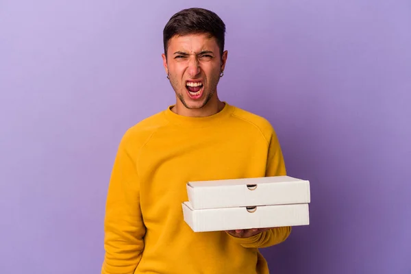 Young Caucasian Man Holding Pizzas Isolated Purple Background Screaming Very — 스톡 사진