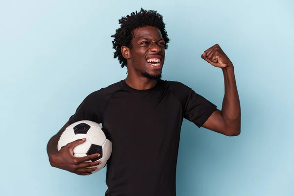 Молодий Американець Який Грає Футбол Ізольований Синьому Фоні Піднімає Кулак — стокове фото
