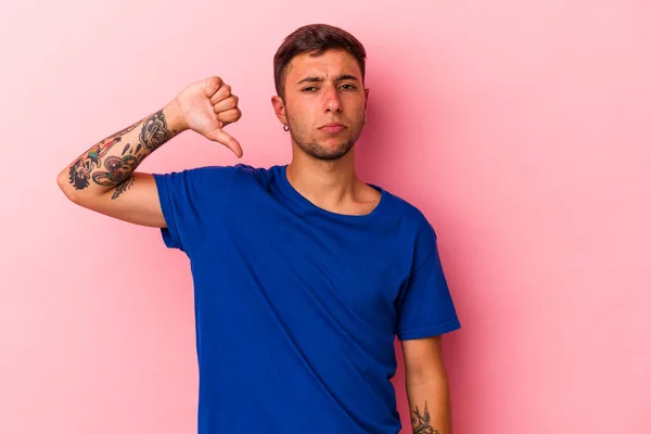 Young Caucasian Man Tattoos Isolated Yellow Background Showing Dislike Gesture — стоковое фото