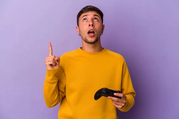 Junger Kaukasischer Mann Hält Spielcontroller Isoliert Auf Violettem Hintergrund Und — Stockfoto