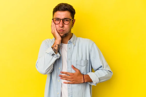 Young Caucasian Man Tattoos Isolated Yellow Background Blows Cheeks Has —  Fotos de Stock