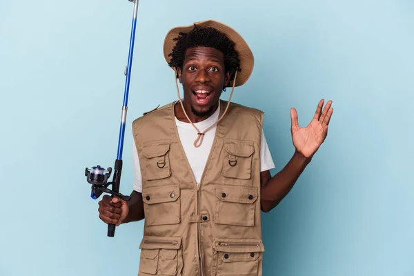 Young African American Fisherman Holding Rod Isolated Blue Background Receiving — ストック写真