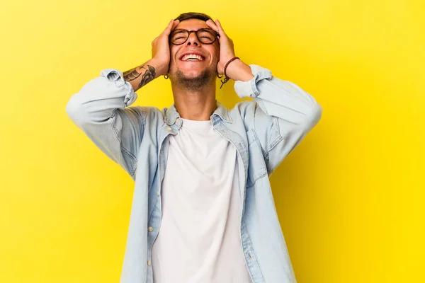 Young Caucasian Man Tattoos Isolated Yellow Background Laughs Joyfully Keeping —  Fotos de Stock