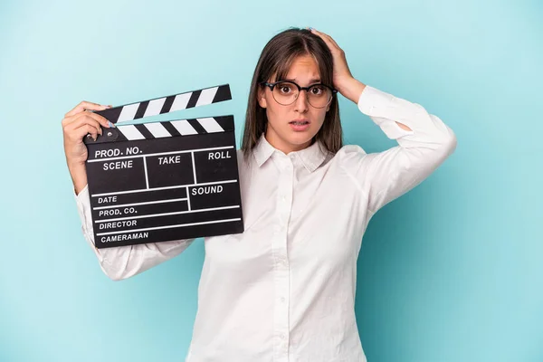 Young Caucasian Woman Holding Clapperboard Isolated Blue Background Being Shocked — 图库照片