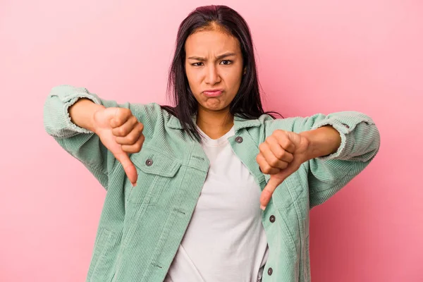 若いラテン語の女性は 親指を示すピンクの背景に孤立し 嫌いを表現 — ストック写真