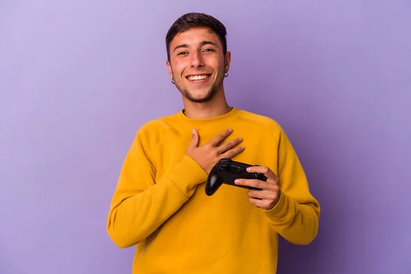 Young Caucasian Man Holding Game Controller Isolated Purple Background Laughs — Foto Stock