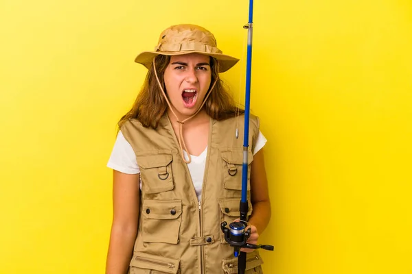 Young Caucasian Fisherwoman Holding Rod Isolated Yellow Background Screaming Very — Stock Photo, Image