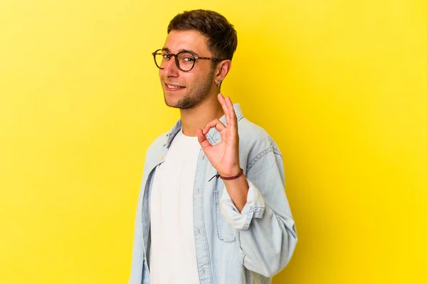 Young Caucasian Man Tattoos Isolated Yellow Background Winks Eye Holds — 스톡 사진