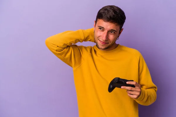 Young Caucasian Man Holding Game Controller Isolated Purple Background Touching — Fotografia de Stock