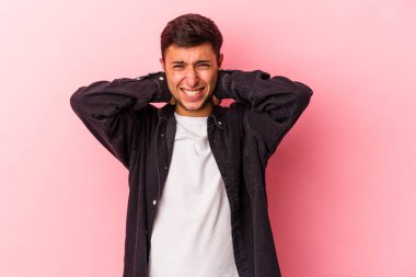 Sarı arka planda izole edilmiş dövmeleri olan genç beyaz bir adam öfkeyle bağırıyor..