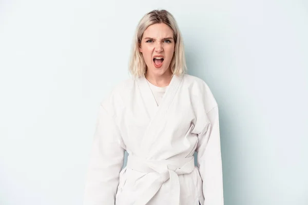 Young Caucasian Woman Doing Karate Isolated Blue Background Screaming Very — Foto de Stock