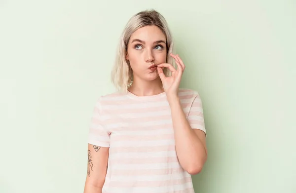 Young Caucasian Woman Isolated Green Background Fingers Lips Keeping Secret — Stock Photo, Image