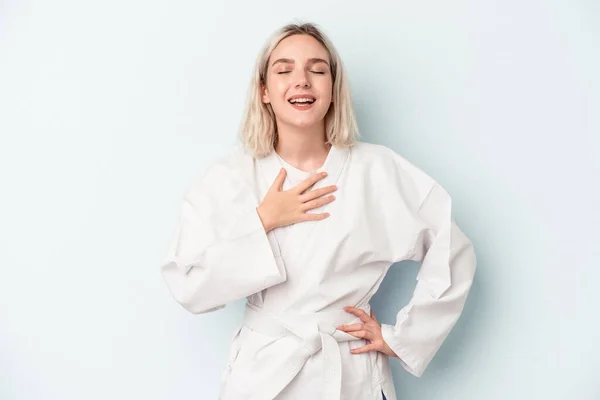 Young Caucasian Woman Doing Karate Isolated Blue Background Laughs Out — Foto de Stock