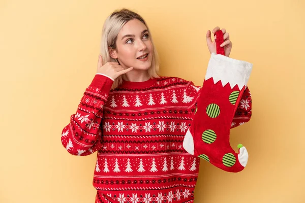 Young Caucasian Woman Holding Elf Sock Isolated Yellow Background Showing — Stock Photo, Image