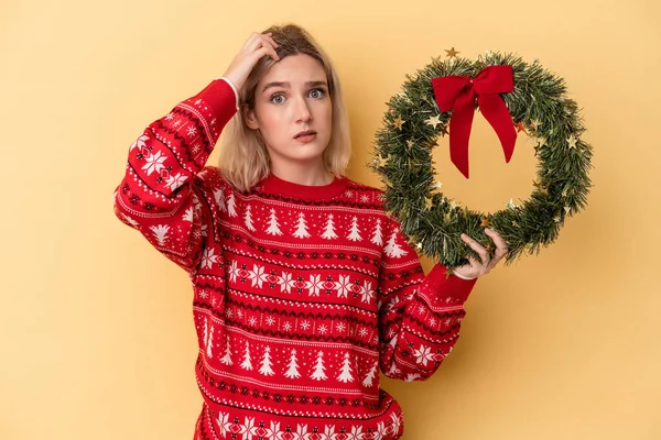 Young Caucasian Woman Holding Christmas Wreath Isolated Yellow Background Being — Photo