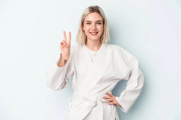 Young Caucasian Woman Doing Karate Isolated Blue Background Showing Number — Foto de Stock