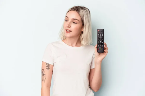 Young Caucasian Woman Holding Controller Isolated Blue Background Looks Aside — Foto de Stock