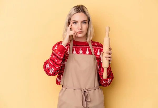 Young Caucasian Baker Woman Doing Cookies Christmas Isolated Yellow Background — стоковое фото
