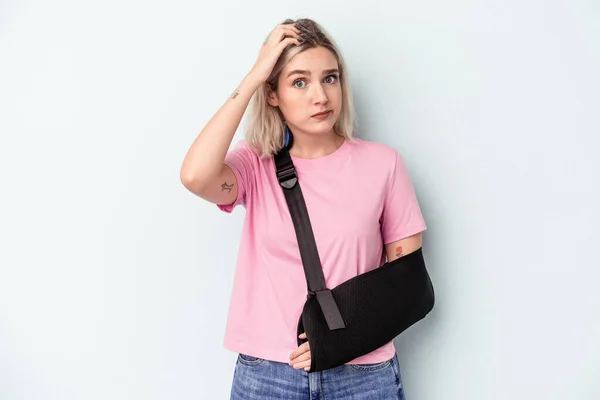 Young Caucasian Woman Broken Hand Isolated Blue Background Being Shocked — Stock Photo, Image