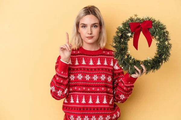 Young Caucasian Woman Holding Christmas Wreath Isolated Yellow Background Showing — Foto de Stock