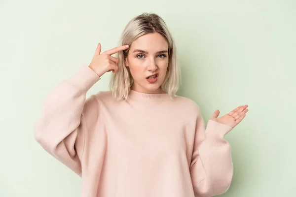 Young Caucasian Woman Isolated Green Background Showing Disappointment Gesture Forefinger — Stock Photo, Image