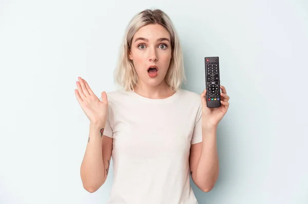 Young Caucasian Woman Holding Controller Isolated Blue Background Surprised Shocked — стоковое фото