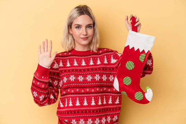 Young Caucasian Woman Holding Elf Sock Isolated Yellow Background Smiling — Stock Photo, Image