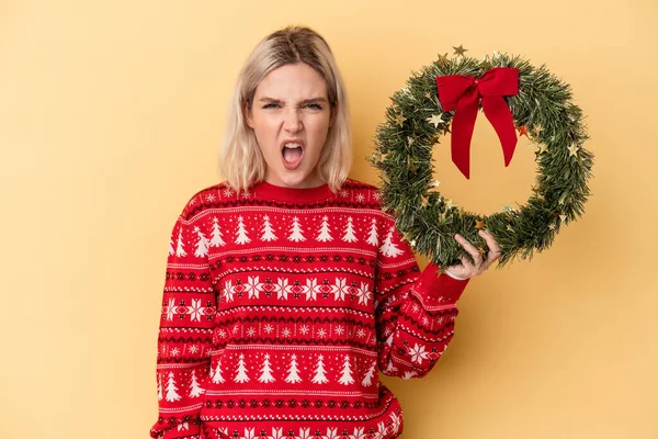 Young Caucasian Woman Holding Christmas Wreath Isolated Yellow Background Screaming — Foto Stock