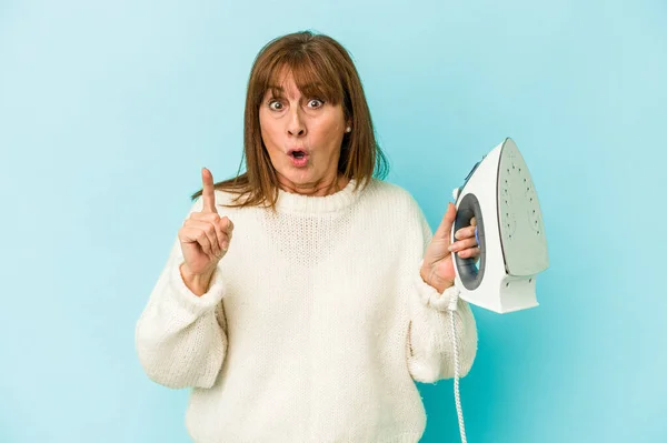 Middle Age Caucasian Woman Holding Iron Isolated Blue Background Having — Φωτογραφία Αρχείου