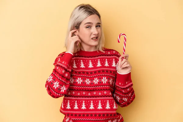 Young Caucasian Woman Holding Christmas Stick Isolated Yellow Background Covering — Stock Photo, Image