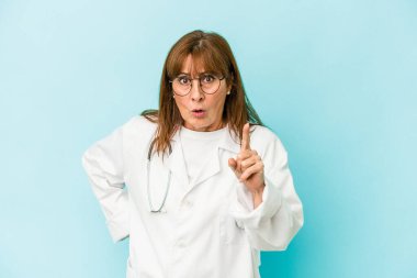 Middle age doctor woman isolated on pink background having an idea, inspiration concept.