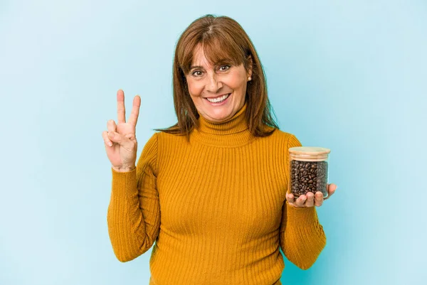 Middle Age Woman Holding Coffee Jar Isolated Blue Background — Fotografia de Stock