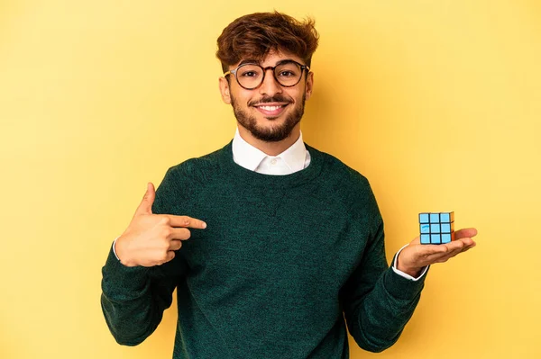 Mladý Smíšené Rasy Muž Drží Rubiks Kostky Izolované Žlutém Pozadí — Stock fotografie
