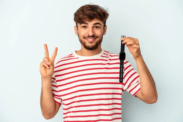 Young Mixed Race Man Holding Wrist Watch Isolated Blue Background — Foto Stock