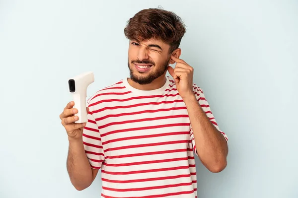 Young Mixed Race Man Holding Thermometer Isolated Blue Background Covering — Fotografia de Stock