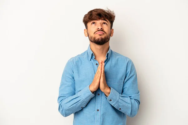 Young Mixed Race Man Isolated Grey Background Holding Hands Pray — Stockfoto