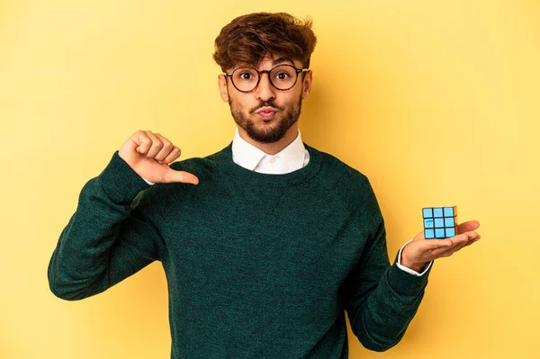 Mladý Smíšený Rasový Muž Drží Kostku Rubiks Izolované Žlutém Pozadí — Stock fotografie