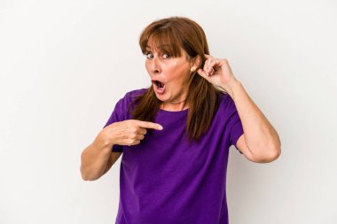 Beyaz arka planda izole edilmiş orta yaşlı beyaz kadın bir dedikoduyu dinlemeye çalışıyor..