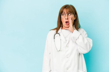 Middle age doctor woman isolated on pink background is saying a secret hot braking news and looking aside