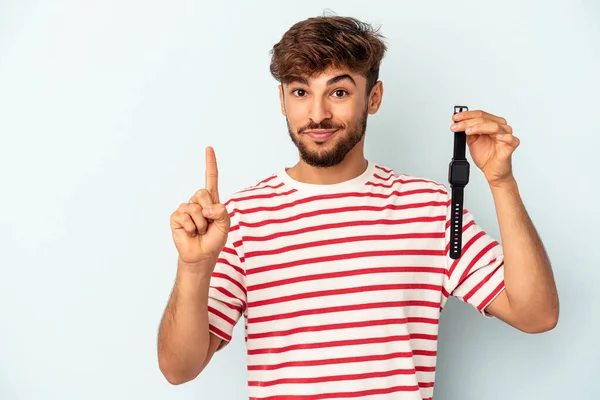 Young Mixed Race Man Holding Wrist Watch Isolated Blue Background — Foto Stock