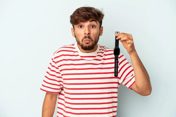 Young Mixed Race Man Holding Wrist Watch Isolated Blue Background — Foto Stock